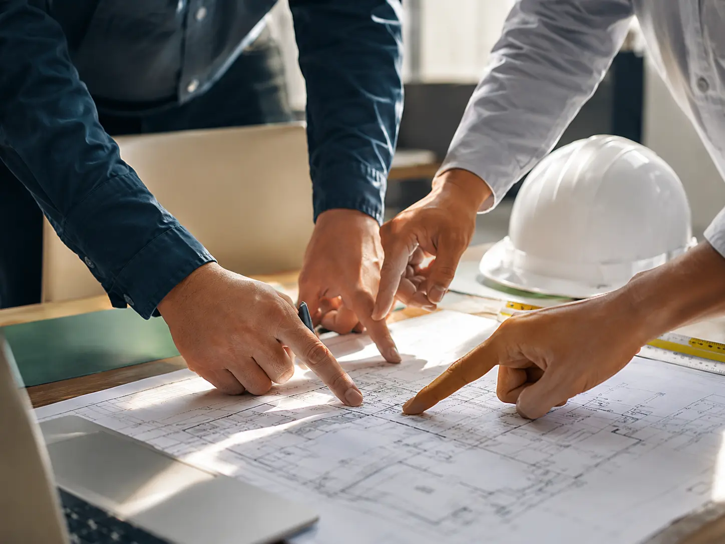 Construction and project management team reviewing building plans in Oxford